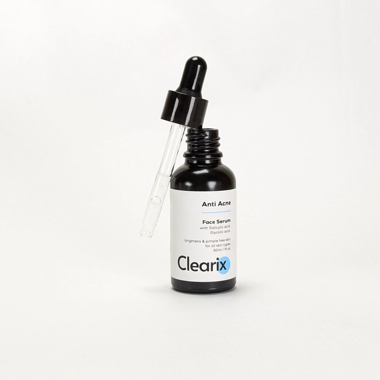Clearix Anti Acne Face Serum displayed against a white background. The image features a 30ml black dropper bottle with the dropper slightly lifted, showing the serum inside. Formulated with salicylic acid and glycolic acid, the serum helps brighten the skin and maintain a pimple-free complexion. Suitable for all skin types.