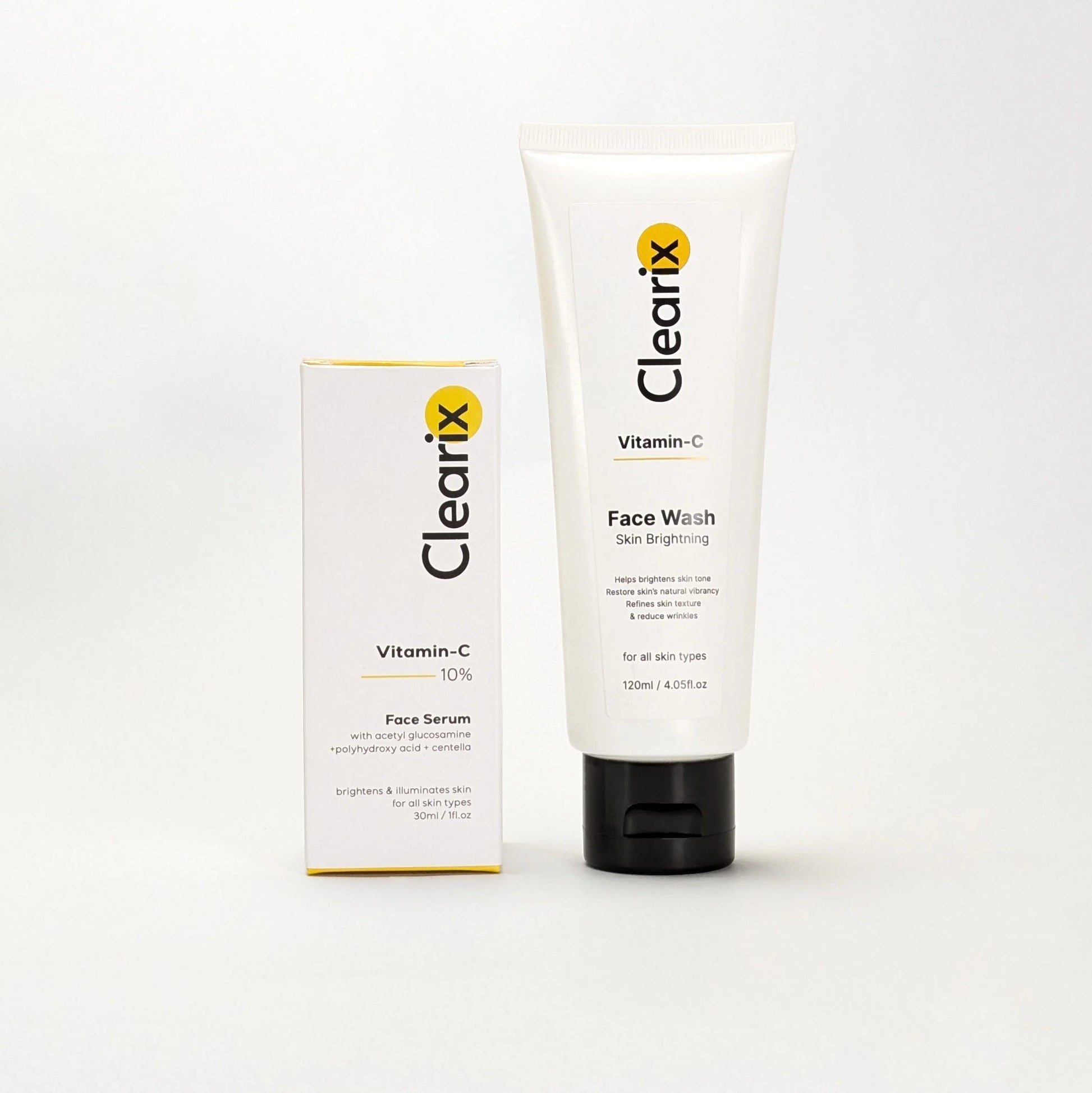 Clearix skincare products displayed against a white background. The image features two items: a Clearix Vitamin-C Face Serum in its white packaging box, formulated with acetyl glucosamine, polyhydroxy acid, and centella for brightening and illuminating skin, and a Clearix Vitamin-C Face Wash in a white tube designed for skin brightening, restoring natural vibrancy, and reducing wrinkles.