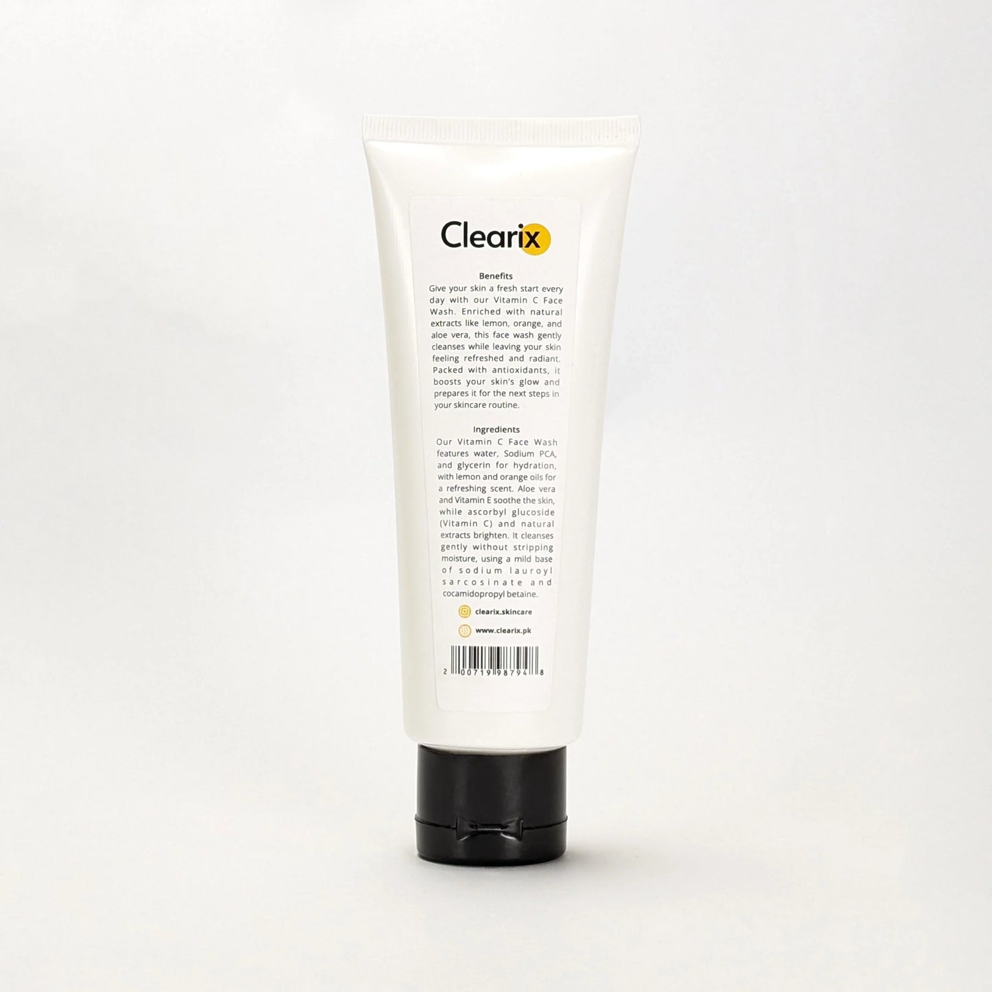 Clearix Vitamin-C Face Wash displayed against a white background. The image features a 120ml white tube with a black flip-top cap, showing the back label with product benefits, ingredients, and a barcode. Enriched with Vitamin C, aloe vera, and natural extracts, the face wash helps brighten skin tone, restore radiance, and refine texture. Suitable for all skin types.