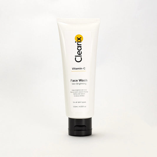 Clearix Vitamin-C Face Wash in a white tube with a black flip-top cap, displayed against a plain white background. The label emphasizes skin brightening, improving texture, reducing wrinkles, and restoring natural vibrancy. Suitable for all skin types.