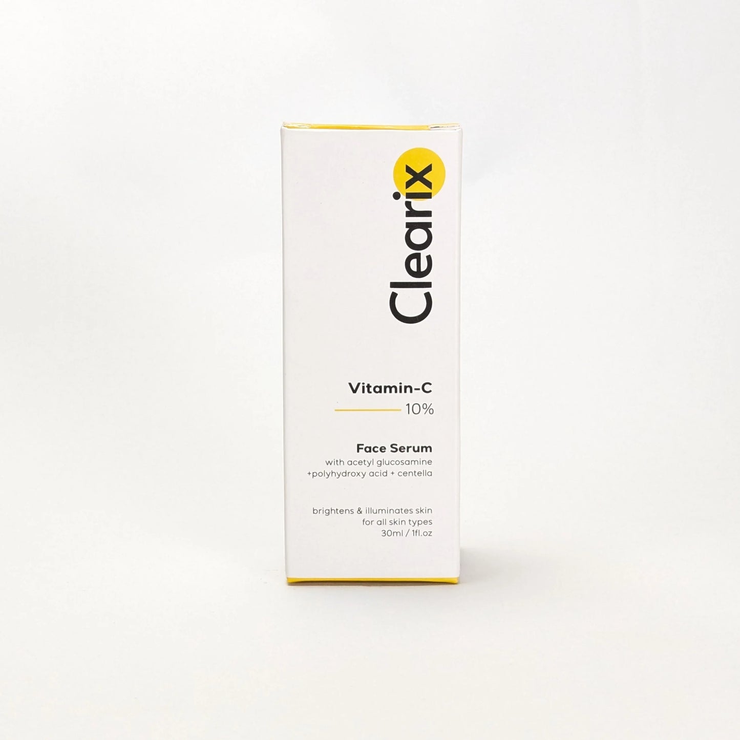 Clearix Vitamin-C 10% Face Serum packaging displayed against a white background. The image showcases a sleek white box with black and yellow branding. Formulated with acetyl glucosamine, polyhydroxy acid, and centella, the serum brightens and illuminates the skin. Suitable for all skin types.