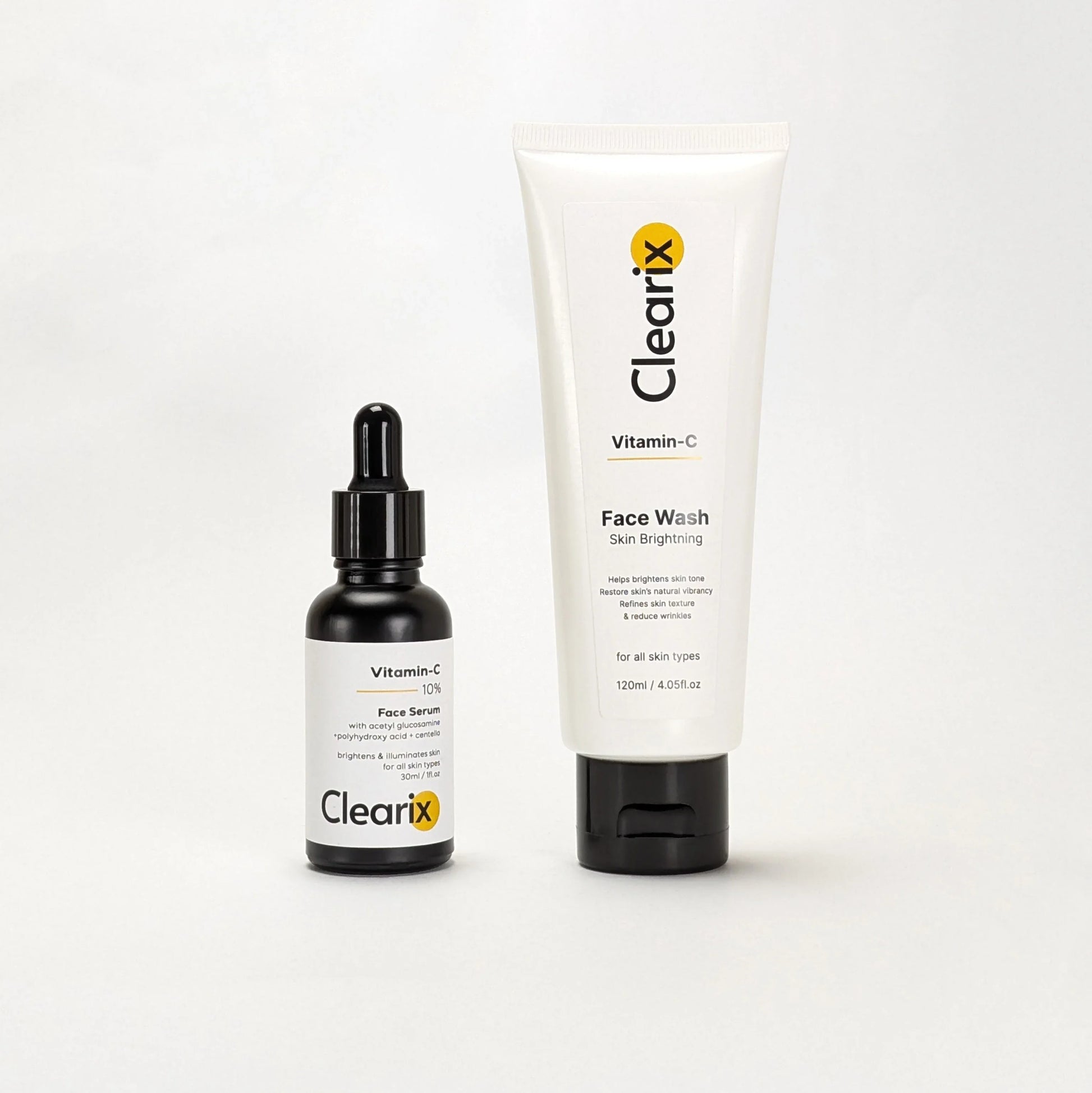 Clearix skincare products displayed against a white background. The image features two items: a Clearix Vitamin-C Face Serum in a black dropper bottle, formulated with ethyl ascorbic acid, polyhydroxy acid, and ceramides for brightening and skin illumination, and a Clearix Vitamin-C Face Wash in a white tube designed for skin brightening, restoring natural vibrancy, and reducing wrinkles.