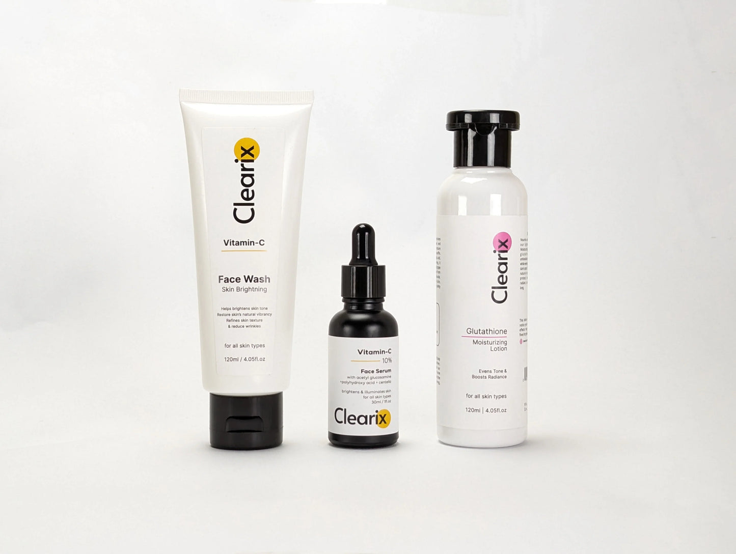 Clearix skincare products displayed against a white background. The image features three items: a Clearix Vitamin-C Face Wash in a white tube for skin brightening, a Clearix Vitamin-C 10% Face Serum in a black dropper bottle for enhanced radiance, and a Clearix Glutathione Moisturizing Lotion in a white bottle with a flip-top cap for hydration and even skin tone. Each product is formulated to nourish, brighten, and improve overall skin health.